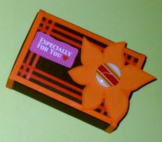 Altered Matchbox - I made the box because I wanted something larger than the normal 32 count matchbox. I drew the flower on orange paper and used a brad to attach it onto the box. Hope you like it! :D