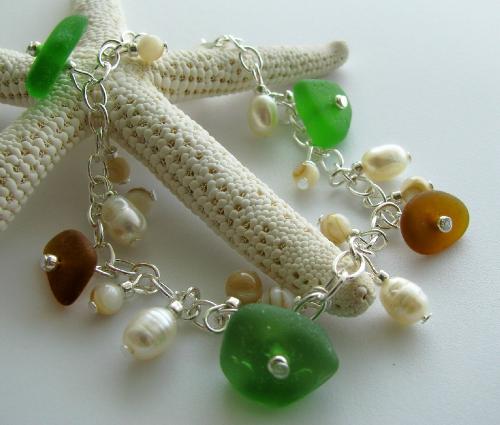 Green and Amber Brown Sea Glass Bracelelt - This 7 1/2' silver plated bracelet is adorned with 3 greens and 2 amber brown pieces of genuine sea glass. Fresh water pearls and polished shell beads accent this bracelet. A great summer accessory that will transition nicely into autumn.  Available in my shop on Etsy.com