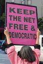 internet - A protester holding up a sign that reads, 'keep the net free and democratic'