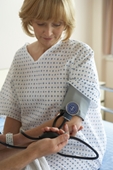 medical checkup - photo of doctor checking woman's blood pressure