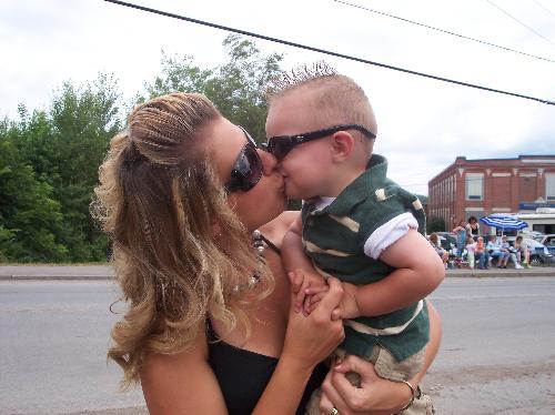 me and the love of my life - This is a picture of my son and I. My husband has 2 children from a previous marrage. He always told me there was no love like the love you have for your children. For the first time in his life, I have to admit that his is right(ha,ha I don't admit that he is right a lot.) My son is the love of my life. This picture was taken during our town's home coming parade. The parade has been a life long tradition for me. My dad lives in one of the best spots to watch the parade. We always get front row seats and never have to fight anyone off. I'm proud to carrie the tradition on with my son. Over the years of this parade tradition somethings have changed and some stayed the say. It is funny how something a simple as a parade can bring so many memories.
