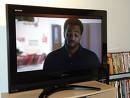 new technology woes - Picture of a lcd tv with a african american man in the screen with a weary look on his face