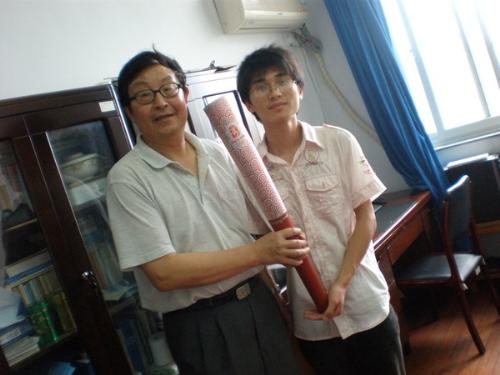torch - the left is my Olympic teacher,he is the flame relayer,the right is my classmates,it is in his office.