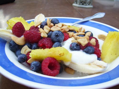 Breakfast banana split - I topped my banana with raspberries, blue berries, pineapple yogurt and nuts. 