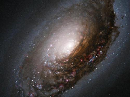Evil Eye Galaxy - A collision of two galaxies has left a merged star system with an unusual appearance as well as bizarre internal motions. Messier 64 (M64) has a spectacular dark band of absorbing dust in front of the galaxy&#039;s bright nucleus, giving rise to its nicknames of the "Black Eye" or "Evil Eye" galaxy.
