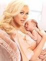 Some celebs fear the implications of pregnancy - Picture of christina aguilera looking to the camera in a silk white robe gown holding her tiny nude newborn baby against her chest