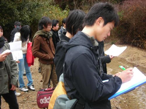 Students on a Field Trip - This is a picture showing students taking down notes from their instructor during a field trip in the Okayama prefecture, Japan.