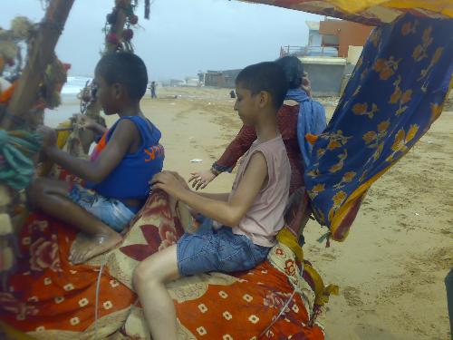 Kids&Camel - Here is my son with his friends riding a camel alongside a sea. Riding a camel is a joy trip for most of the kids, however there must be a jokey to control the animal.