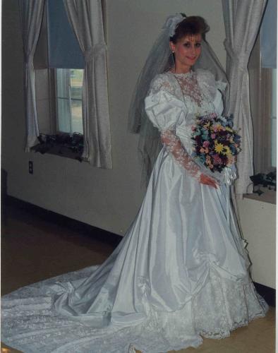 Me in my wedding gown 17 years ago - It's a right pretty gown and bought it on the spot at the bridal store. It looks much more expensive that it is. I paid somewhere around $325. that's it!! But I sure do love it!