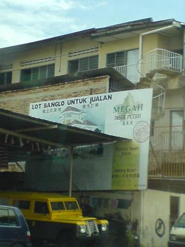 Advertisement need shade too - Nowadays advertisement need shade from hot weather. The owner of this used car dealer did not bother to remove the ads before setting up the tent.Maybe it's too costly to remove and disposed off or the advertisement belongs to a different owner who refused to dismantle the ads.