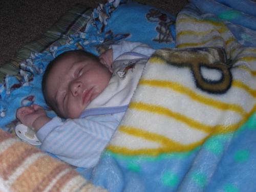 Justin taken by GG Mary - Justin asleep on the couch with his favorite blankets