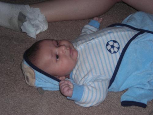 Justin taken by GG Mary - Justin laying on the floor in front of mommy
