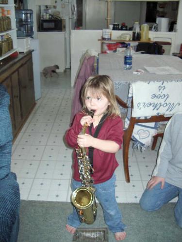 Momma's little sax player - Sieara trying out her uncle's sax.