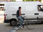cycling - Van and cyclist compete for the road.