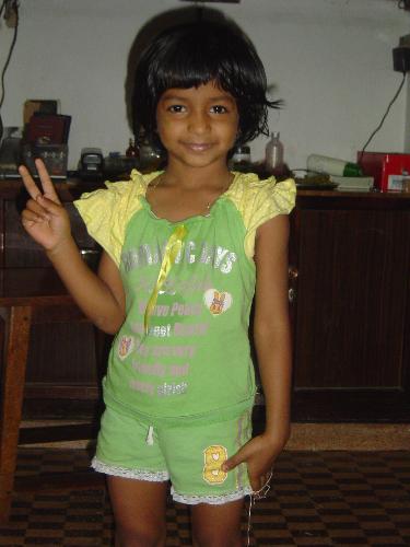 Trisha at 5 years..  - This is how she looked when she was 5 years old.. Very naughty girl.. My sister and her family is now in Japan.. Thats why she is showing her hands like that.. V for Victory... :)
