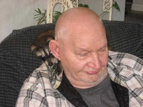 My father - Sitting with Missy, my daughters racoon crawling on his shoulders and nibbling his earlobe ever so often.