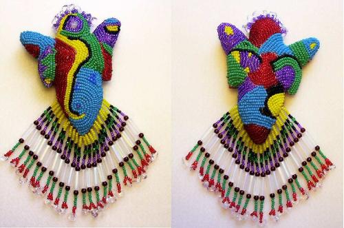 Spirit Doll - This is a muslin doll stuffed with cotton batting. The surface is completely covered with bead embroidery in various colors, sizes, textures and patterns.