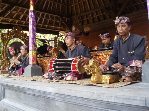 Music pavilion  - Sitting at the audience seat in front of the outdoor stage in the Bali Island cultural center, we could see there was a music pavilion at the right side of the outdoor stage. A team of musicians were playing music with their traditional musical instruments to accompany the performance of drama or dancing on the stage. All the musicians looked absorbed in playing with their individual instruments. They were wearing they traditional costume.