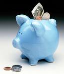 all adds up - A mini blue piggy bank with a dollar sticking out of the top and some change stuck in the slot, coins in front of it