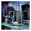 technician cleaning system unit - the technician carefully cleans the system unit of the PC