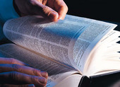 dictionary - photo of man thumbing thru dictionary