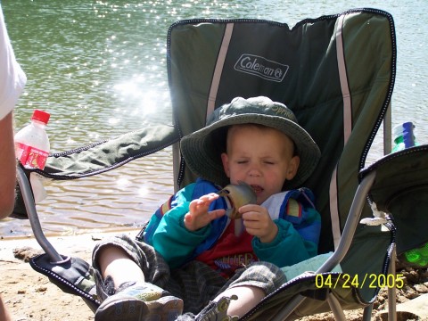 My son and his first fish - My youngest son on his first fishing trip and holding his first fish.
