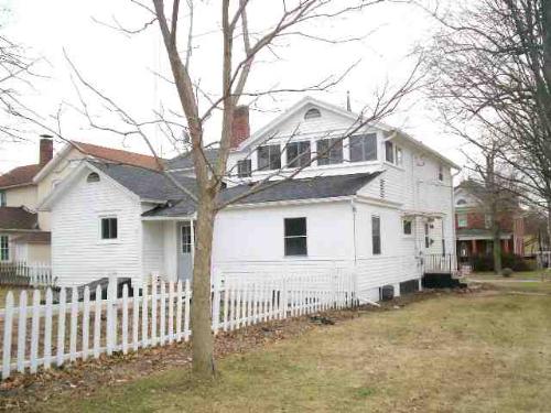 This is the back side view of Our property in down - This House is always for sale. We bought it in 1996. Currently the taxes per year run us 2,500 per year in 2008. The house beginnings Were built in 1888. It like all older homes is in need of a few more repairs, but in the last 2 years we have added new windows from all the basement windows right down to every window, except the 2 that we put in new in 1997 when we converted a huge porch into a 3rd room, hall and first floor laundry. The property has old horse stables that are now garages. Apparently at one point the fifth garage stall was sold with the property on 9th street, and so now it only has 2 garages that are 2 cars each. The neighbor owns the 5th 1 car garage that is attached. It has a easement where it means that if they paint it and it looks much worse, then they need to paint my sides, or if I paint mine and theirs looks much worse then I must paint theirs to make it stay looking kind of decent.