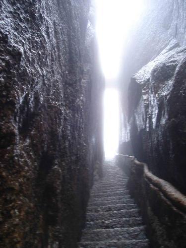 Bottle Neck Climb - This is a picture of the steep climb that goes through the Yellow Mountains in China. You can see the steep steps that are also narrow and ancient looking that are carved between the mountains. You'll only find this kind of mountain soil condition in one other place on earth, in Iowa-our historic Loess Hills.
