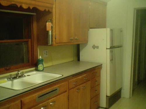 kitchen in old home top floor 1 bedroom rental uni - This old house has a unique kitchen and great newer ammenities that they even forget in new homes now sometimes, like a double sink. Or deep double sinks, the frig has been replaced since the picture was taken. Rented