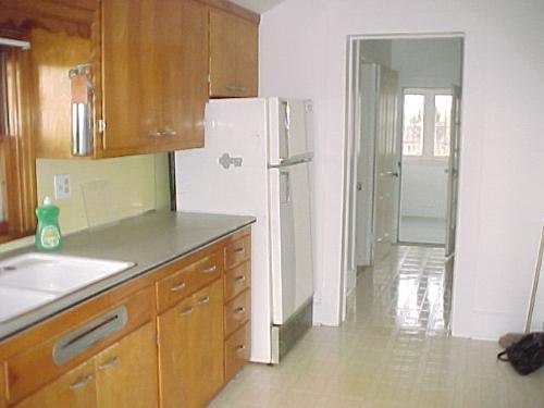 upstairs kitchen narrow looking toward wrap around - this old house has charm and appeal You can't buy today. plaster walls, lead in the paint a couple or more layers back, floor to ceiling top floor windows, rental rented, Monroe, Wisconsin