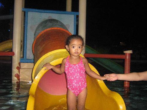 esmie's night swimming birthday party - charlette on the slide in the kiddie pool