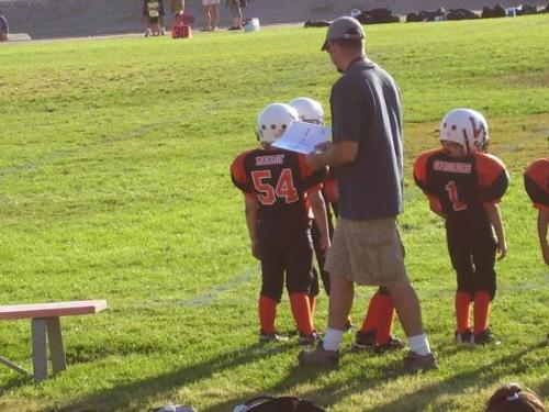 my seven year old's first football game - Standing on the sidelines during his first football game.