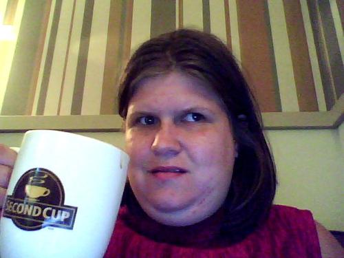 Me! - This is the picture I took to test out the webcam that came with my brand new laptop. I'm sitting in my favourite chair in my favourite cafe, in the whole entire world!! The coffee cup I'm holding, says it all.