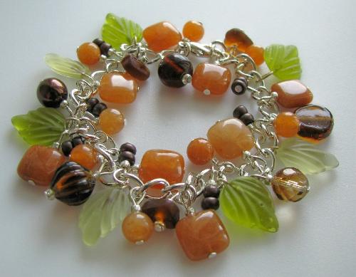 Autumn Beauty Bracelet - Green glass leaves and red aventurine stones are accented by various size-shape glass beads in rich choclate browns on this 7 1/2' bracelet. Avail in my Etsy shop!