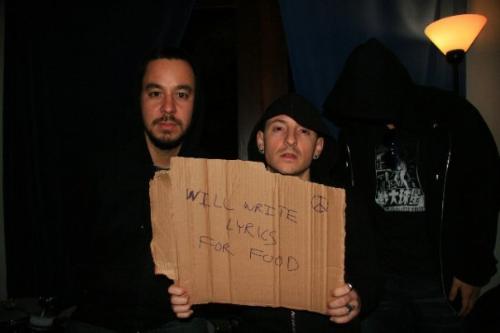 Mike and Chester (Linkin Park) - Holding a sign up to amuse themselves and fans at a gig