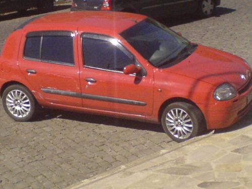 Renault Clio - A red Renault Clio. It has some scratches in it's side.