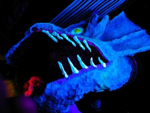Derek the Dragon - papermache dragon stands about 4ft tall with a roar of about 50cm diameter. we used airconditioning duct and chicken wire to create the dimensions, then papermache sculpted the finer details. Painted in black light reactive paints
