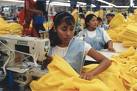This is who gave you 'falling prices' - Picture of women slaving away in sweatshop sowing piles of yellow sweatshirts