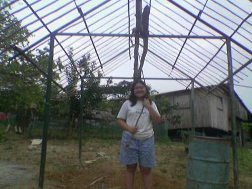 my daughter messing around the on going constructi - its going to be my small hut. near the big hut
