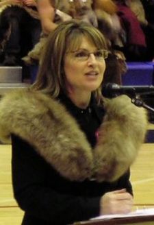 Sarah supports fur trappers - Picture of Sarah Palin at at podium with two large furs on her shoulders