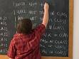 does the firmer hand work - Picture of a child facing a chalkboard with the board covered in sentences