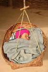 child - child sleeping in cradle
