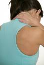 forget 'taco neck' - Picture of back of a lady with sky blue shirt and head down with hand holding her neck in pain