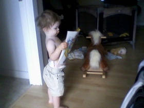 Reading - This my son Memphis, he is looking at a tattoo magazine. He loves to read and isn't even 2 yet.