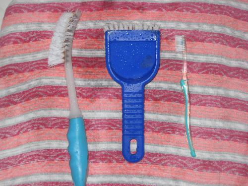 Toilet, Bathroom cleaning tools - Used toothbrush, blue square brush and corner brush