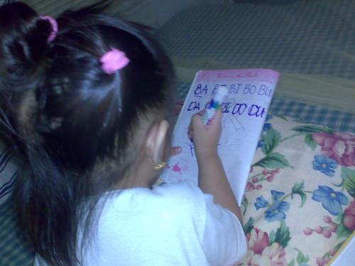 children - a baby writing
