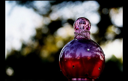 Fantasy Perfume - It's all about the bottle! The bottle is just gorgeous! I love its round shape, the playful fuscia color, and the little rhinestones that adorn the bottle