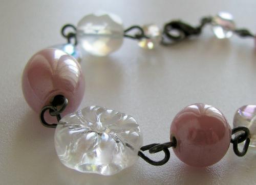 Pink Lustre Bracelet - This 7 1/2' bracelet is made of antiqued silver and pink lustre glass beads with clear faceted, flower and heart shaped beads. Very pretty and feminine with a shabby-chic look! Finished with a lobster clasp also in antiqued silver.  Available in my shop on Etsy.com