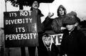 Will it ever be disarmed? - Picture of people people rallying one holding up signs saying 'Its not diversity, its perversity'