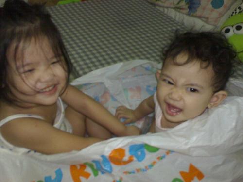 simple happiness - The picture shows my 2 happy nieces inside a big plastic bag.